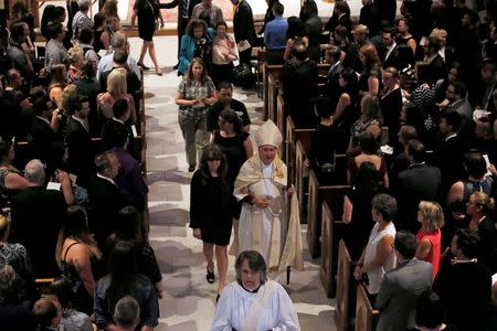 Christine Leinonen, mother of Christopher Leinonen, who was killed at the Pulse gay nightclub, is escorted out of Cathedral Church of St. Luke after a a funeral service for her son in Orlando, Florida, U.S. June 18, 2016. REUTERS/Jim Young