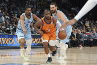 Phoenix Suns' Chris Paul (3) heads to the basket as Memphis Grizzlies' De'Anthony Melton 0, guards in the second half of an NBA basketball game Friday, Nov. 12, 2021, in Memphis, Tenn. (AP Photo/Karen Pulfer Focht)