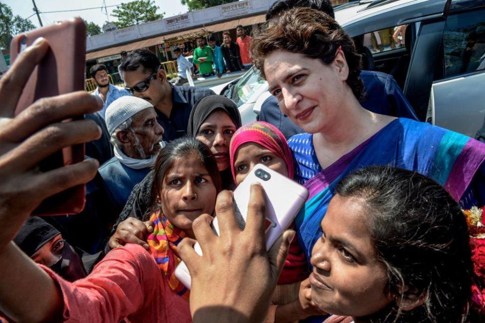 Young women pose for a selfie with Congress Party's Priyanka Gandhi during her campaign on March 27, 2019 in Uttar Pradesh, India. 