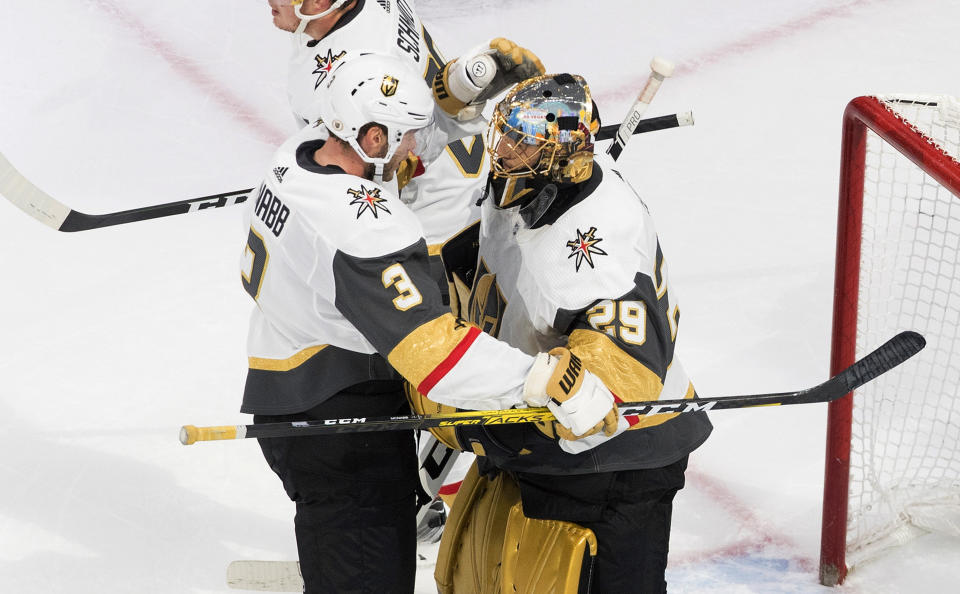 Vegas Golden Knights' Brayden McNabb (3) and goalie Marc-Andre Fleury (29) celebrate the win over the Chicago Blackhawks in an NHL hockey Stanley Cup first-round playoff series, Saturday, Aug. 15, 2020, in Edmonton, Alberta. (Jason Franson/The Canadian Press via AP)