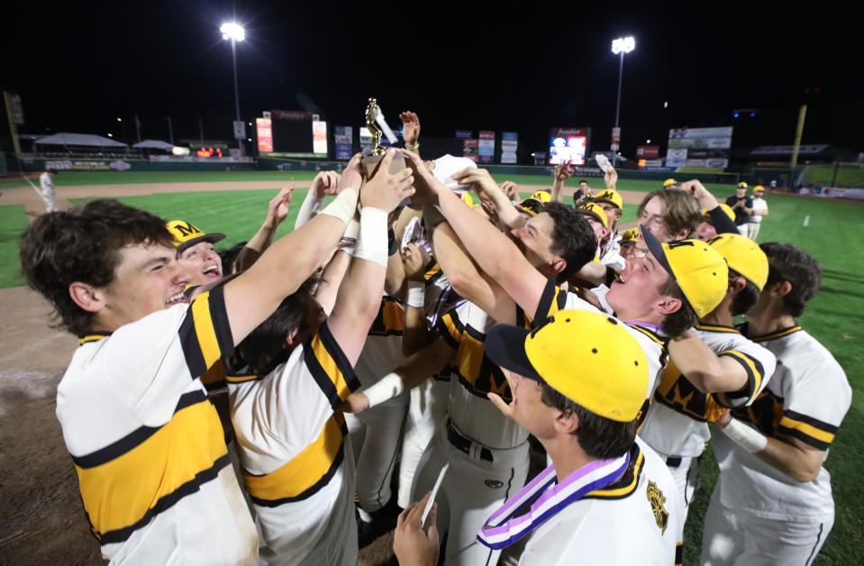 McQuaid players celebrate with the Championship trophy  after their Section V Class AA championship final win over Victor at Frontier Field Tuesday, May 31, 2022 in Rochester.  McQuaid won the game and championship 2-1. 