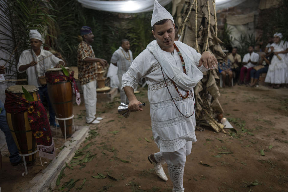 Thiago Viana, who is also known as Father Thiago of Oxum, of the Afro Brazilian faith Candomble, leads a ritual honoring Obaluae, the deity of earth and health, in a temple on the outskirts of Salvador, Brazil, Sunday, Sept. 18, 2022. Viana was caught in the crossfire of a religiously tinged political attack on former President Luiz Inacio Lula da Silva, who leads all polls against incumbent Jair Bolsonaro, in the Oct. 2 presidential election. (AP Photo/Rodrigo Abd)