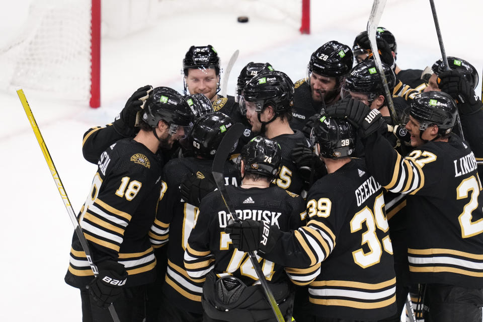 Boston Bruins center Pavel Zacha (18) is congratulated by teammates after his winning goal against the Florida Panthers in an overtime period of an NHL hockey game, Monday, Oct. 30, 2023, in Boston. (AP Photo/Charles Krupa)