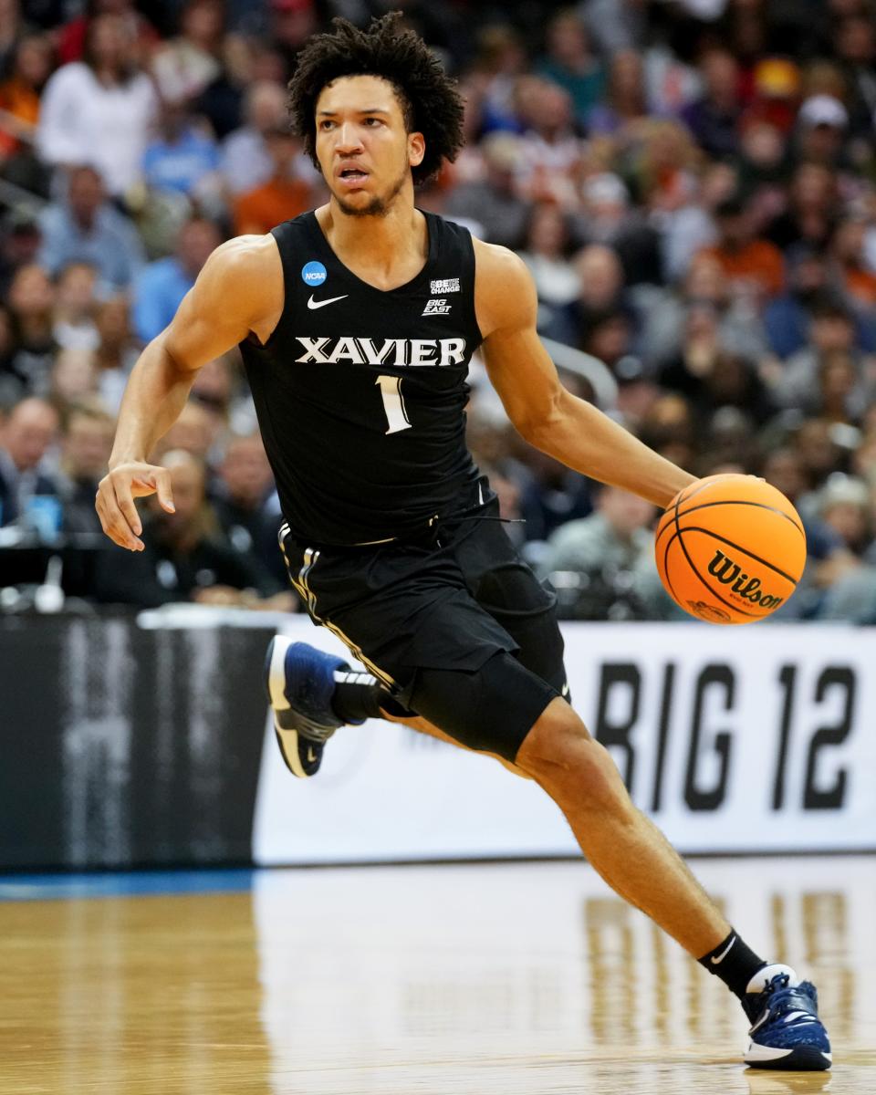 Xavier Musketeers guard Desmond Claude (1) dribbles during the first half of a Sweet 16 college basketball game between the Xavier Musketeers and the Texas Longhorns in the Midwest Regional of the NCAA Tournament, Friday, March 24, 2023, at T-Mobile Center in Kansas City, Mo.