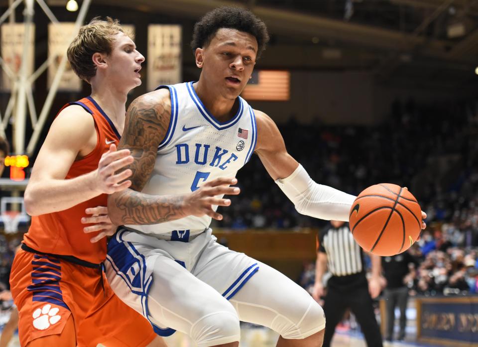 Jan 25, 2022; Durham, North Carolina, USA;  Duke Blue Devils forward Paolo Banchero (5) handles the ball in front of Clemson Tigers forward Hunter Tyson (5) during the second half at Cameron Indoor Stadium. The Blue Devils won 71-69.