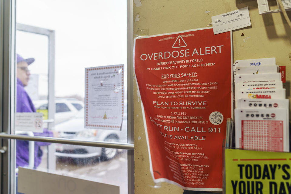 A sign calling attention to drug overdoses is posted to the door of a gas station on the White Earth reservation in Ogema, Minn., Tuesday, Nov. 16, 2021. The drug crisis has diversified; it is no longer an opioid epidemic but one in which people are dying from deadly cocktails of many drugs. Deaths involving methamphetamine have nearly tripled in recent years, with Native Americans now 12 times more likely to die from it. (AP Photo/David Goldman)