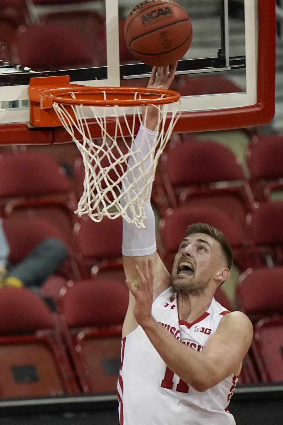 Wisconsin's Micah Potter shoots during the first half of an NCAA college basketball game against Wisconsin-Green Bay Tuesday, Dec. 1, 2020, in Madison, Wis. (AP Photo/Morry Gash)