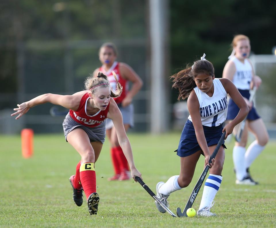 Red Hook's Kylee Knuschke pressures the ball against Pine Plains' Arely Soria during a Sept. 29, 2021 field hockey game.