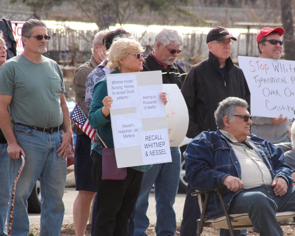 Supporters of Marlena Pavlos-Hackney, owner of Marlena's Bistro & Pizzeria, gather at her restaurant Monday, March 22, awaiting a news conference organized by local state Republican legislators. The restaurant was closed Friday, March 19, following Pavlos-Hackney's detainment for violating a court order. [Brian Vernellis/Holland Sentinel]