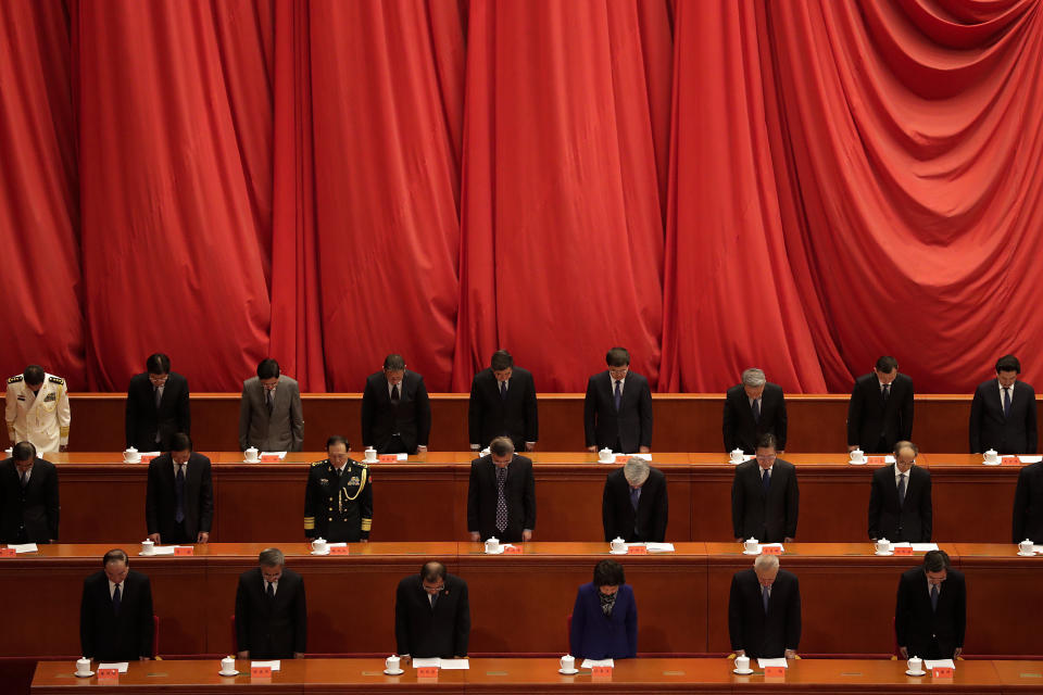 Party officials bow to pay condolences to the soldiers during the commemorating conference on the 70th anniversary of China’s entry into the 1950-53 Korean War, at the Great Hall fo the People in Beijing, Friday, Oct. 23, 2020. (AP Photo/Andy Wong)