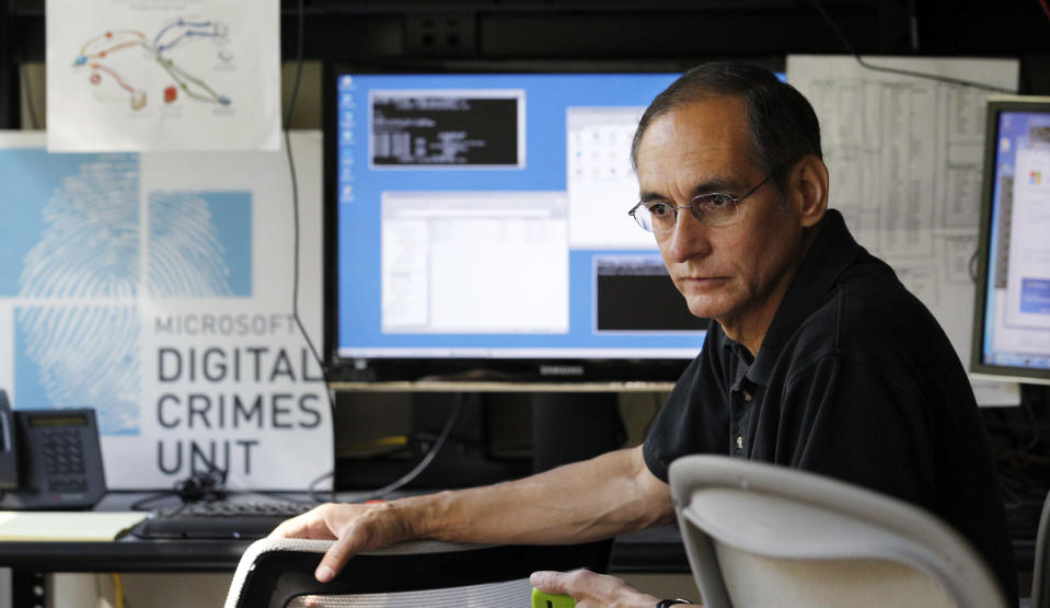 David Anselmi, a Microsoft senior manger of investigations in the company's Digital Crimes Unit, sits in the DCU lab there Wednesday, Sept. 12, 2012, in Redmond, Wash. Documents unsealed Thursday by a federal court in Virginia describe a new front in a legal campaign against cybercrime being waged by Microsoft. The company says evidence shows cybercriminals are now looking for opportunities to inject malicious software and code into counterfeit versions of computer operating systems even before the machines are wrapped in plastic and sold to unsuspecting customers. (AP Photo/Elaine Thompson)