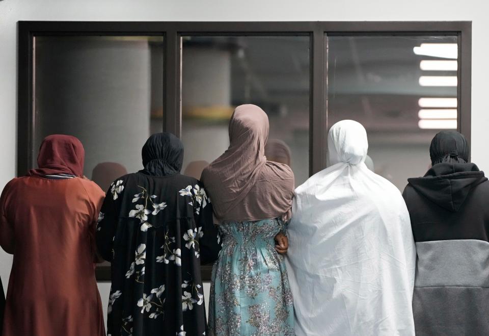 Women watch a prayer session in a room separate from men on Dec. 8, 2023, at Abubakar Assidiq Islamic Center on Columbus' West Side.