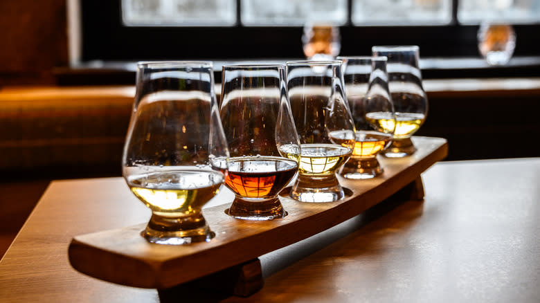 Five glasses of peated whiskey arranged for a tasting