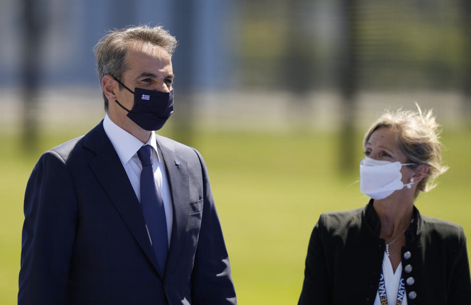 Greek Prime Minister Kyriakos Mitsotakis, left, arrives for a NATO summit at NATO headquarters in Brussels, Monday, June 14, 2021. U.S. President Joe Biden is taking part in his first NATO summit, where the 30-nation alliance hopes to reaffirm its unity and discuss increasingly tense relations with China and Russia, as the organization pulls its troops out after 18 years in Afghanistan.(AP Photo/Francisco Seco, Pool)