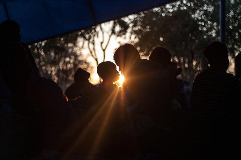 Zimbabwean nationals wake up in a tent at the International Organisation for Migration support centre in Beitbridge, Zimbabwe, on April 21, 2015 after being repatriated fearing xenophobic attacks in South Africa