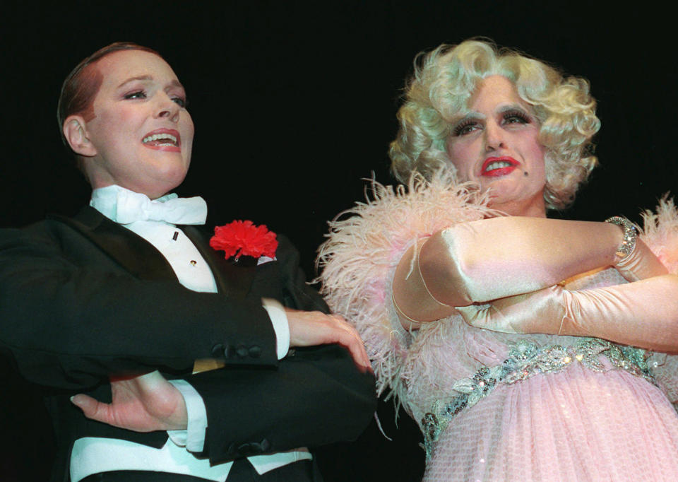 FILE- In this March 1, 1997 file photo, New York Mayor Rudolph Giuliani, right, dressed in drag as a role in "Victor/Victoria," sings with actress Julie Andrews at the New York Hilton during an event presented by the Inner Circle. On Saturday, March 22, 2014, newly elected New York City Mayor Bill de Blasio will make his first appearance before the Inner Circle. The annual Inner Circle dinner is New York City’s answer to the White House Correspondents Dinner. (AP Photo/Joe DeMaria, File)