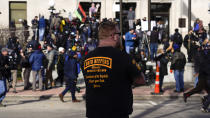 A man wearing an Oath Keepers shirt stands outside the Kenosha County Courthouse, Friday, Nov. 19, 2021 in Kenosha, Wis. Kyle Rittenhouse was acquitted of all charges after pleading self-defense in the deadly Kenosha shootings that became a flashpoint in the nation's debate over guns, vigilantism and racial injustice. (AP Photo/Paul Sancya)