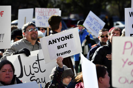 Activists demonstrate against U.S. President-elect Donald Trump ahead of the meeting of the Electoral College at the Texas State Capitol in Austin, Texas, U.S. December 19, 2016. REUTERS/Mohammad Khursheed