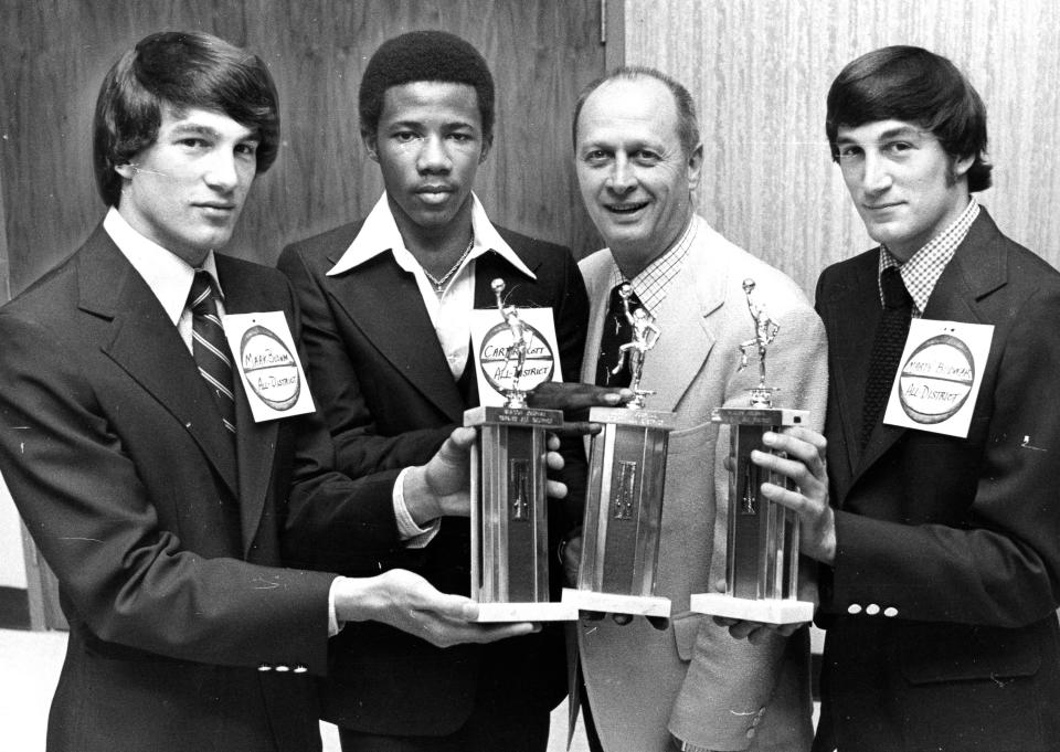From left, Mark Bodnar, Carter Scott, Johnny Orr and Marty Bodnar during an awards ceremony in April 1977. The Bodnar twins and Scott starred for the Barberton High School basketball team. Orr was the head coach at the University of Michigan, where the Bodnars attended.