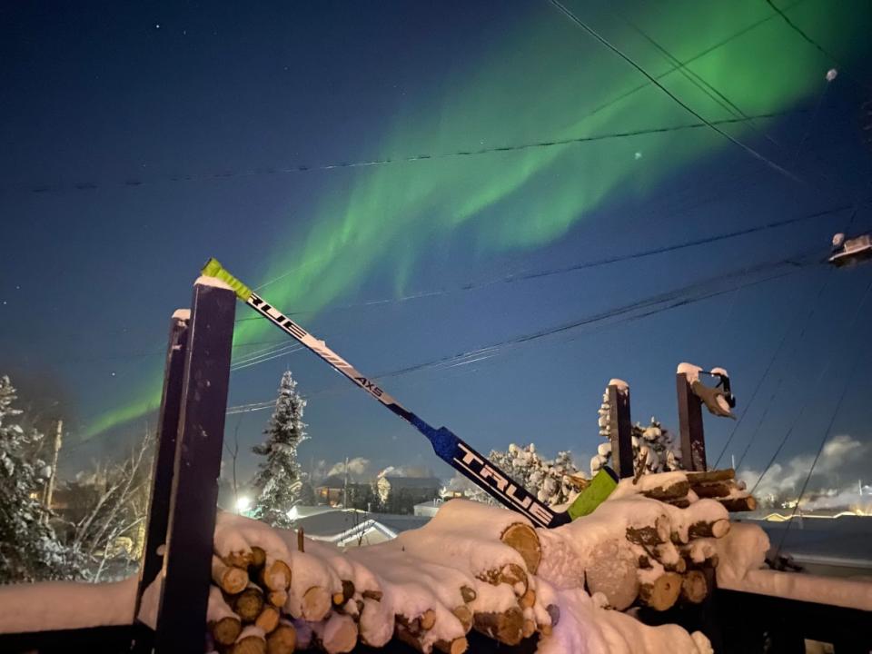 A hockey stick under the northern lights. Parents, board members, and hockey associations in the North are voicing their concerns amid Hockey Canada’s ongoing scandal regarding the organization’s mishandling of sexual assault allegations.   (Submitted by Bill Gordon - image credit)