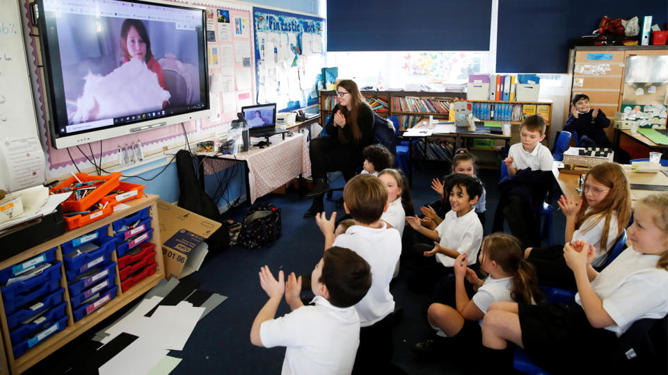 Students at Holne Chase School interact with a class member via the internet as his family is self-isolating amid the Coronavirus disease (Covid-19) in Milton Keynes, Britain, December 1, 2020. (Andrew Boyers/Reuters)