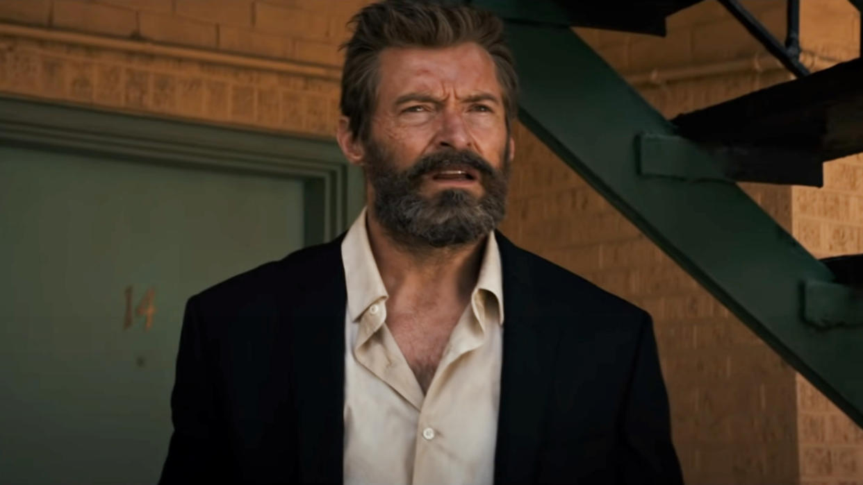  Hugh Jackman looking in the distance from his motel room door in Logan. 