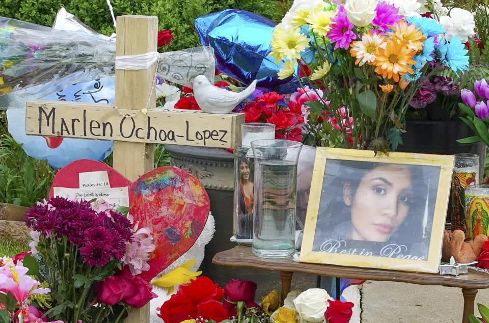 FILE - A memorial of flowers, balloons, a cross and photo of victim Marlen Ochoa-Lopez, are displayed on a lawn, May 17, 2019 in Chicago, outside the home where Ochoa-Lopez was murdered. A Chicago woman accused of luring the pregnant teenager to her home and cutting her baby from her womb with a butcher knife nearly five years ago pleaded guilty to murder Tuesday, April 16, 2024, and was sentenced to 50 years in prison. (AP Photo/Teresa Crawford, File)
