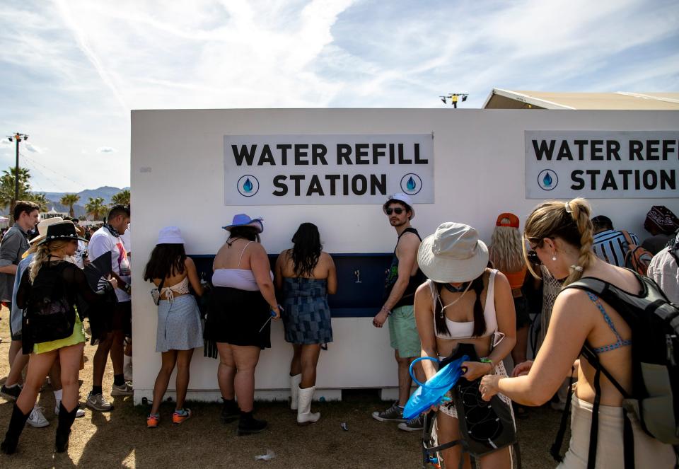 Festivalgoers refill water bottles and bags during the Coachella Valley Music and Arts Festival at the Empire Polo Club in Indio, Calif., Saturday, April 22, 2023. 