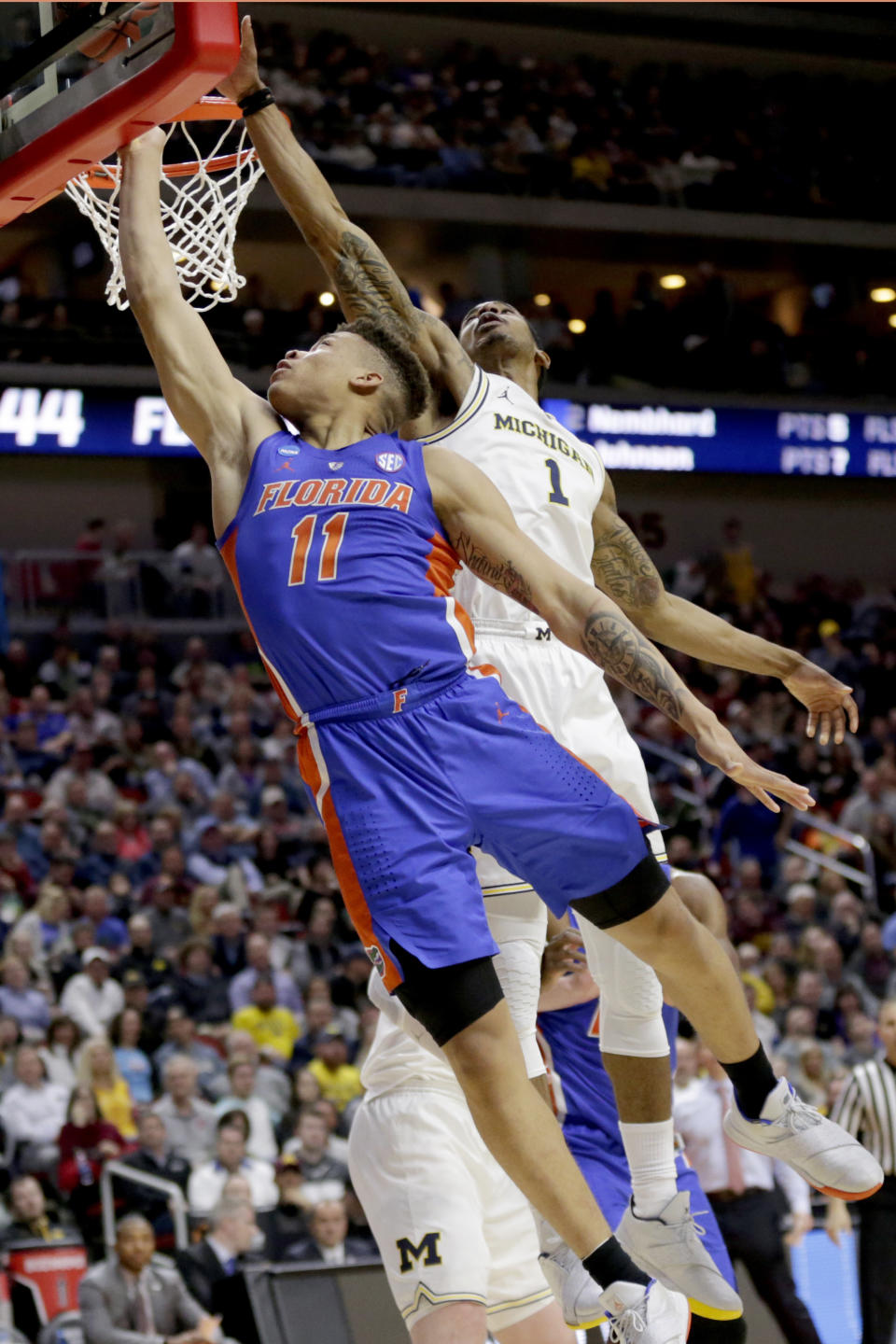 Michigan's Charles Matthews (1) blocks a layup by Florida's Keyontae Johnson (11) during the second half of a second round men's college basketball game in the NCAA Tournament, in Des Moines, Iowa, Saturday, March 23, 2019. (AP Photo/Nati Harnik)