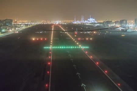 Solar Impulse 2, the solar powered plane, piloted by Swiss pioneer Bertrand Piccard, lands in Abu Dhabi to finish the first around the world flight without the use of fuel, United Arab Emirates July 26, 2016. Jean Revillard, Bertrand Piccard/SI2/Handout via Reuters