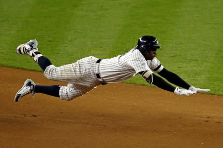 Oct 18, 2017; Bronx, NY, USA; New York Yankees shortstop Didi Gregorius (18) dives into second base for a double during the seventh inning against the Houston Astros in game five of the 2017 ALCS playoff baseball series at Yankee Stadium. Mandatory Credit: Adam Hunger-USA TODAY Sports