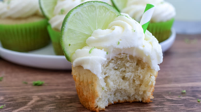 spiked margarita cupcakes with a bite taken out