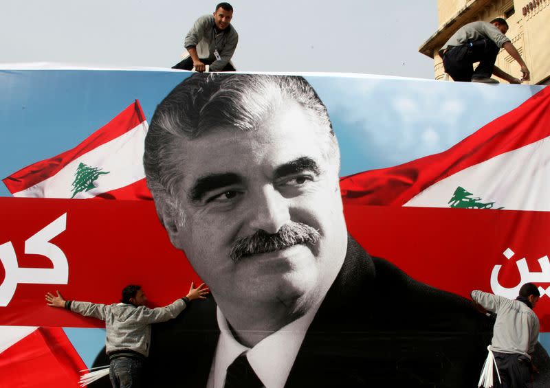 FILE PHOTO: Workers prepare a giant poster depicting Lebanon's assassinated former prime minister Rafik al-Hariri in downtown Beirut