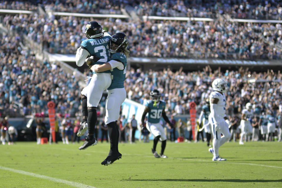 Jacksonville Jaguars cornerback Darious Williams (31) celebrates with teammate Andrew Wingard (42) during the second half of an NFL football game, Sunday, Oct. 15, 2023, in Jacksonville, Fla. (AP Photo/Phelan M. Ebenhack)