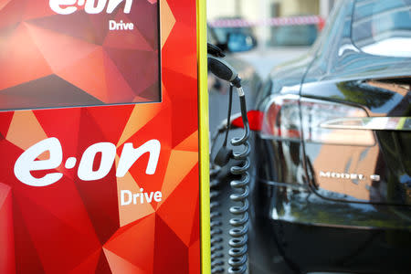 FILE PHOTO: Electric car parking place with the charging stations is seen at the front of the German utility E.ON headquarters in Essen, Germany, May 9, 2018. REUTERS/Wolfgang Rattay/File Photo