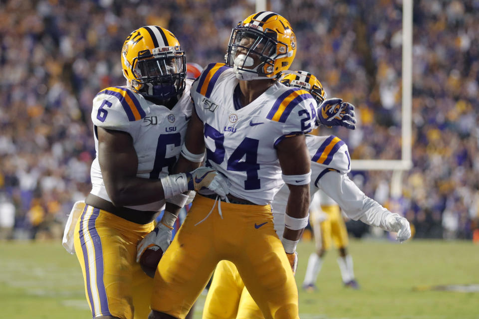 LSU cornerback Derek Stingley Jr. (24) celebrates his interception with linebacker Jacob Phillips (6) in the second half of an NCAA college football game against Florida in Baton Rouge, La., Saturday, Oct. 12, 2019. LSU won 42-28. (AP Photo/Gerald Herbert)