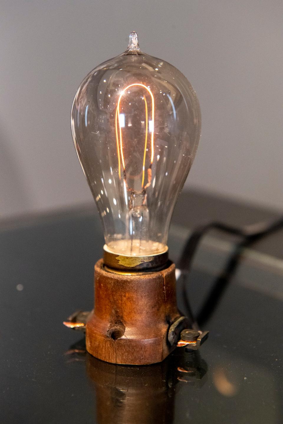 Chad Shapiro lights a 135 year old light bulb in an antique base with half its design voltage by slowly turning it on.