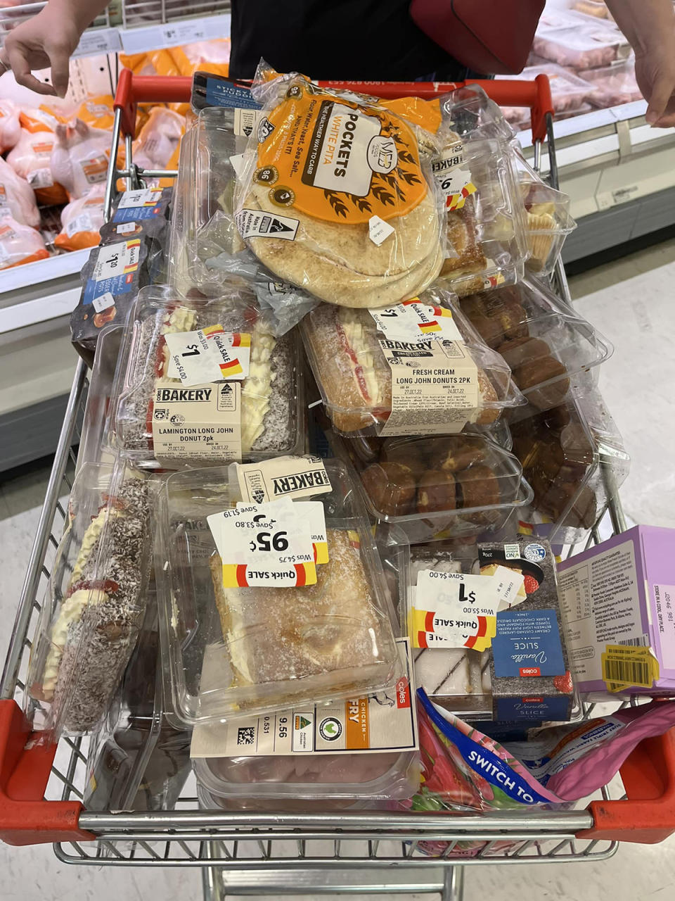 Coles trolley full of cakes and meat