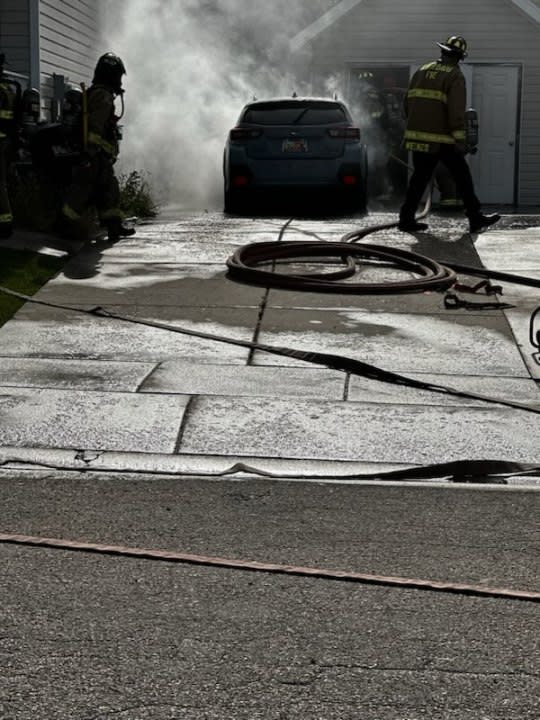 Photos of a car catching fire by a home in Clearfield. (North Davis Fire District Chief Mark Becraft)