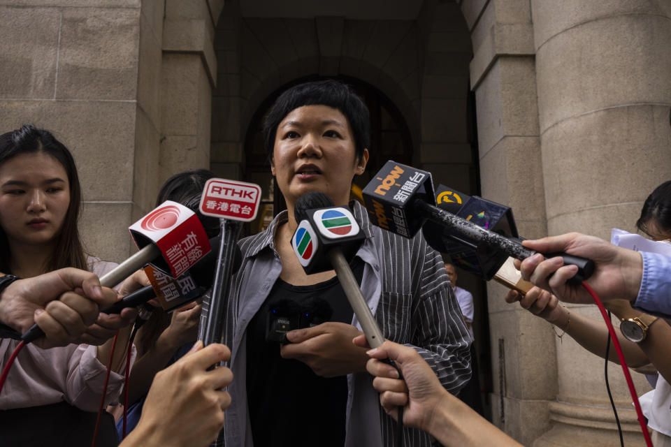 Journalist Bao Choy, center, speaks to members of the press after being cleared by Top Hong Kong court in Hong Kong, Monday, June 5, 2023. The award-winning Hong Kong journalist won an appeal quashing her conviction related to work on her investigative documentary Monday in a rare court ruling upholding media freedom in the territory. (AP Photo/Louise Delmotte)