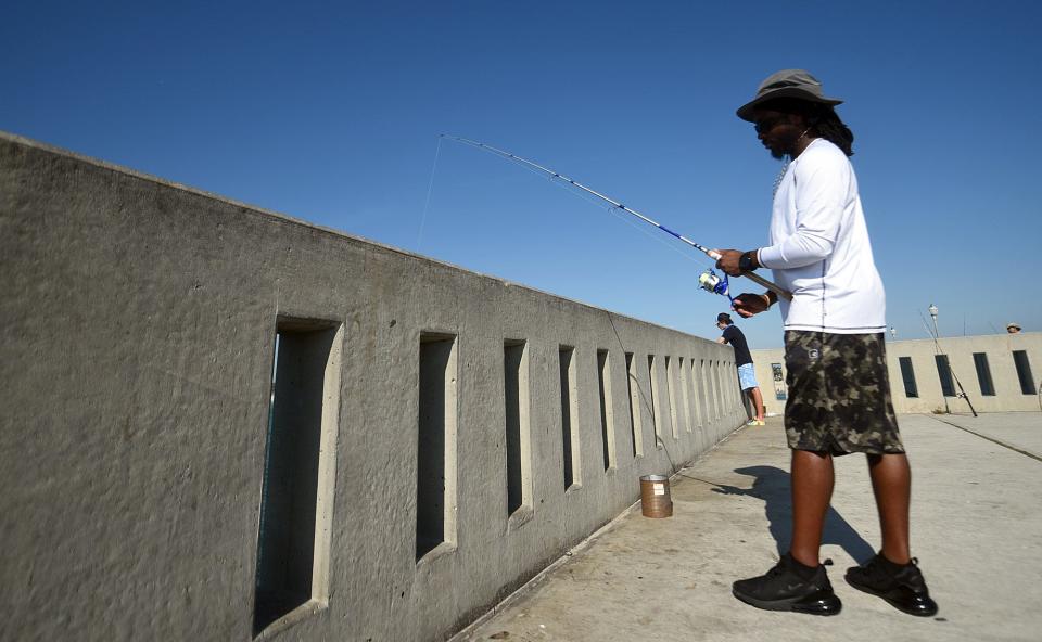 MonTavius Harris fishes off the side of Johnnie Mercer's Fishing Pier at the beginning of Labor Day weekend in Wrightsville Beach, N.C., Saturday, September 6, 2020. Fishing is a great way to enjoy a day in the Wilmington area.