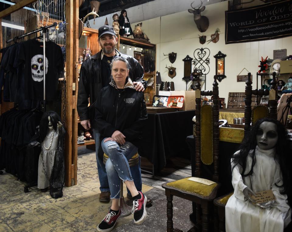 John and Jenifer Harris pose for a portrait Tuesday Jan. 11, 2022, at their newly-opened Voodoo's World of Oddtiques in the REO Town Marketplace on South Washington Avenue in Lansing.