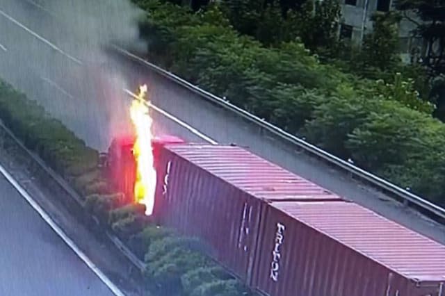 Chinese driver jumps out of truck to escape after the vehicle crashes into central reservation and catches fire