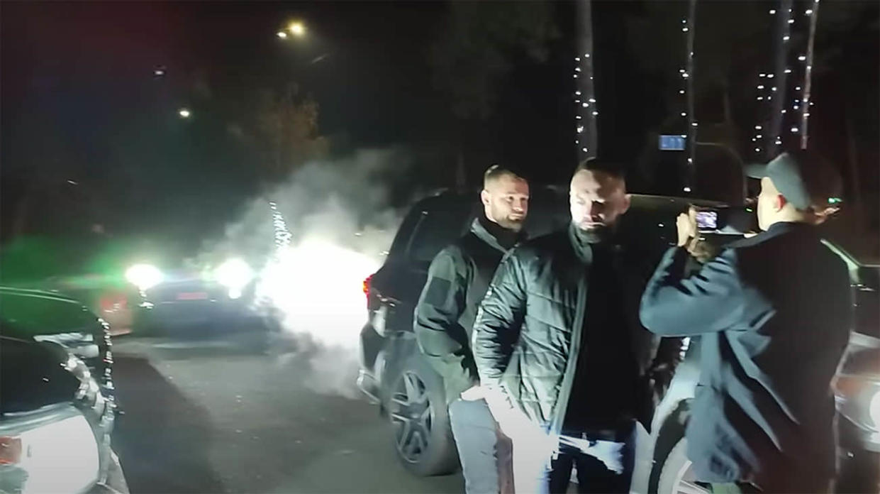 Journalist Mykhailo Tkach and the individuals who attacked him. Photo: Screenshot from video