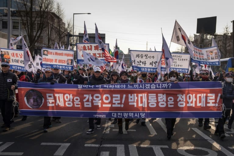 Protestors demonstrate against the visit of North Korean General Kim Yong Chol who will attend the Winter Olympics closing ceremony Sunday