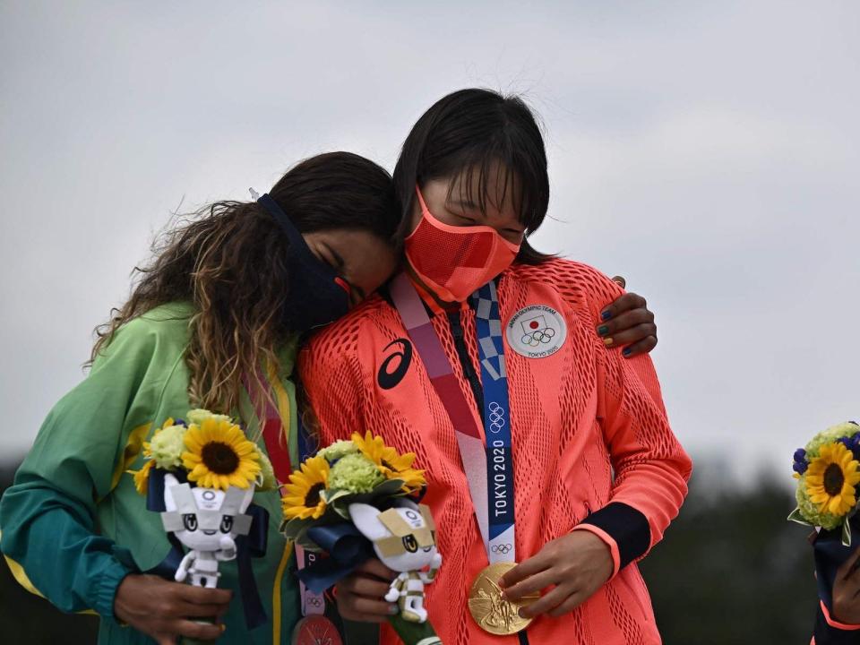 Brazil's Rayssa Leal hugs Japan's Momiji Nishiya during the medal ceremony of the women's street skating final.