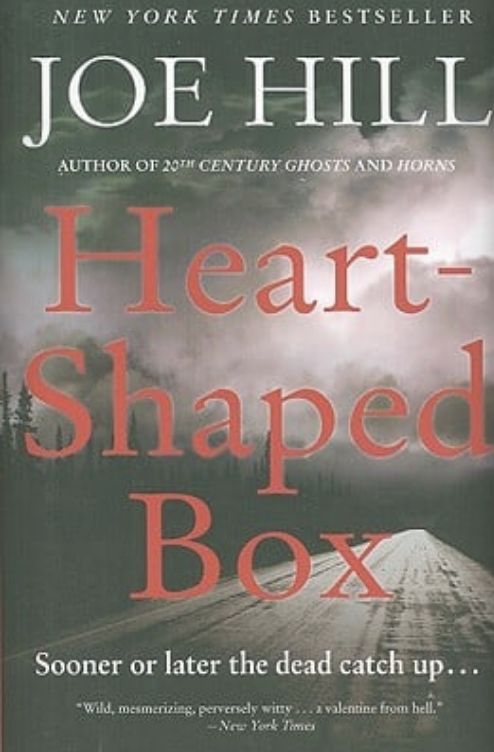 Book cover of "Heart-Shaped Box" by Joe Hill with an ominous road beneath a cloudy sky and the tagline "Sooner or later the dead catch up..."