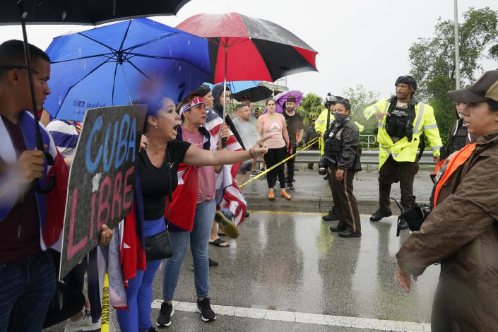 Demonstrators confront police as they try to get onto the Palmetto Expressway, Tuesday, July 13, 2021, in Miami. Demonstrators are protesting in solidarity with the thousands of Cubans who waged a rare weekend of protests around their island nation again the communist regime. (AP Photo/Marta Lavandier)
