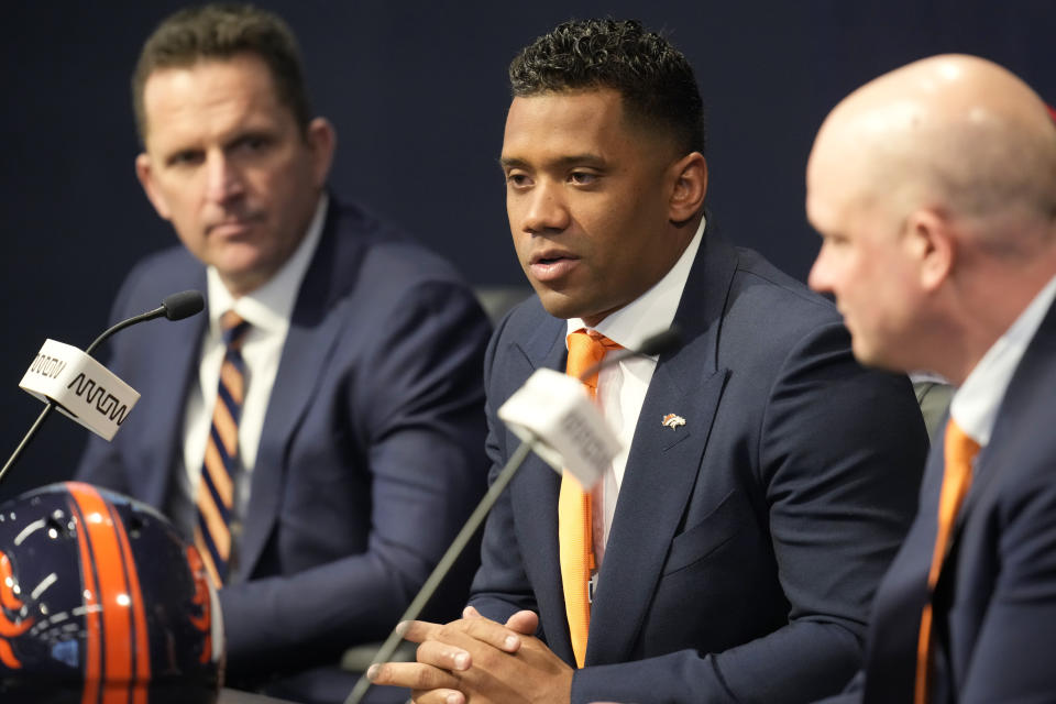 Denver Broncos new starting quarterback Russell Wilson, center, is flanked by head coach Nathaniel Hackett, right, and general manager George Paton during a news conference Wednesday, March 16, 2022, at the team's headquarters in Englewood, Colo. (AP Photo/David Zalubowski)