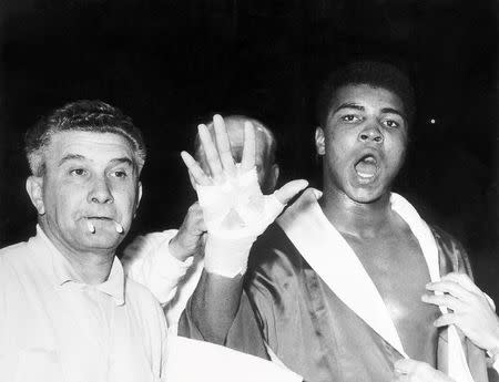 Cassius Clay (R) (later Muhammad Ali) predicts that he will in the fifth round before his fight with Henry Cooper at Wembley Stadium in London, Britain June 18, 1963.Mandatory Credit: Action Images / MSI/File Photo